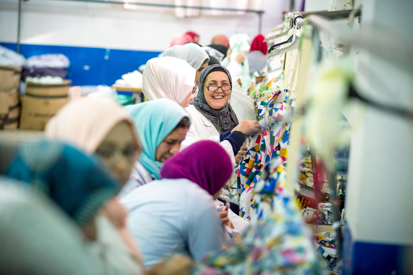 Women organizing finalized clothing pieces in a factory in Morocco